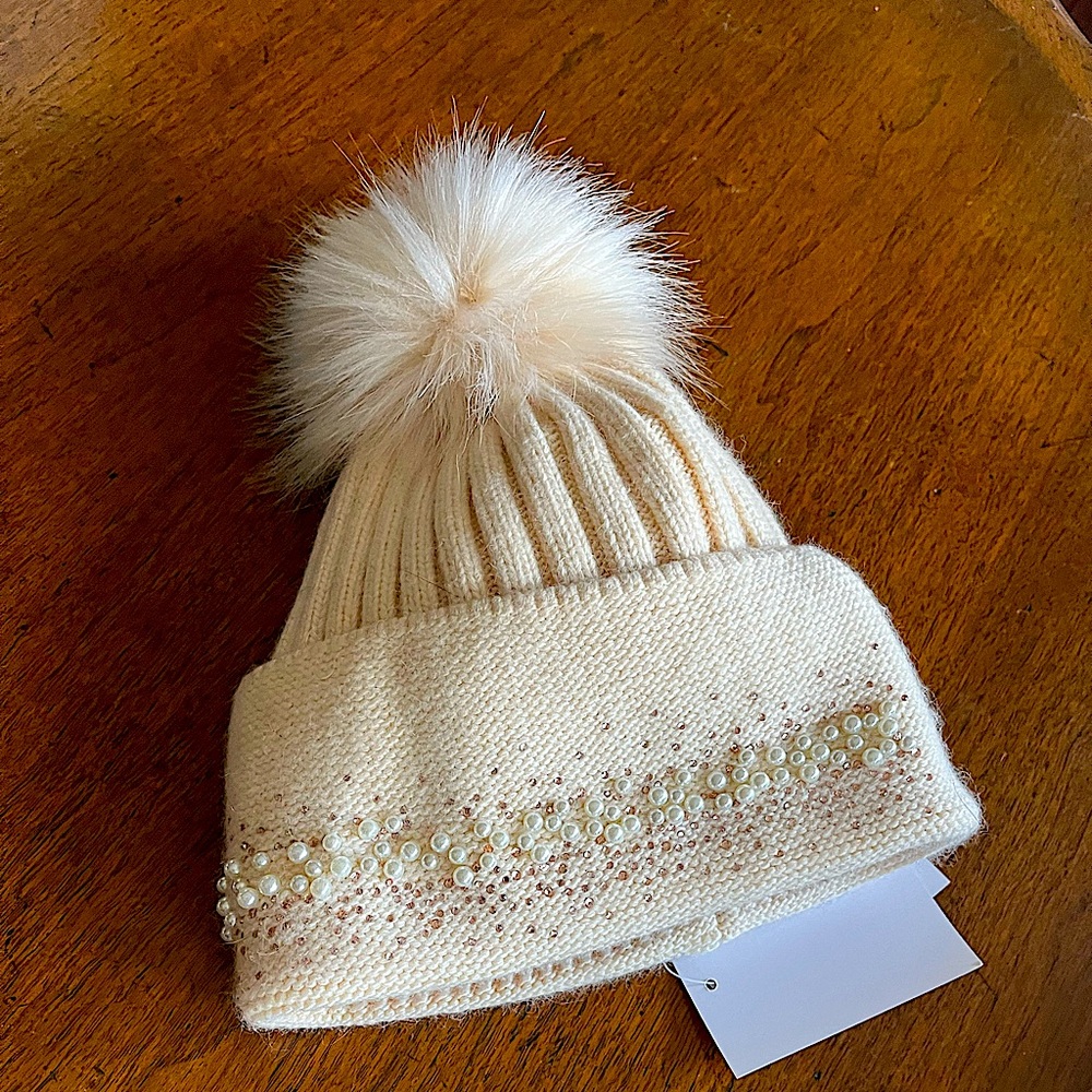 Winter hat with pearl and sequin trim with faux fur pompom. Never worn with tags